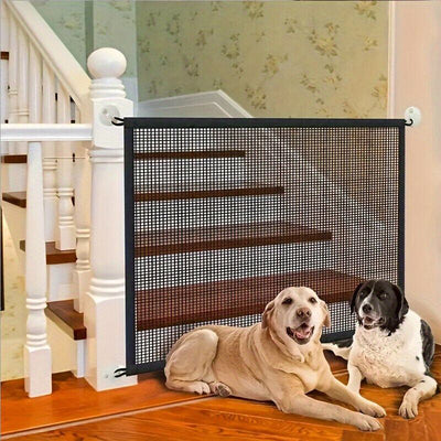 Pet isolation mesh safety fence at stairwell with two dogs in front.