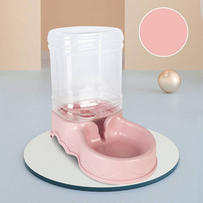 Dog automatic drinking fountain with pink base on a round white platform.