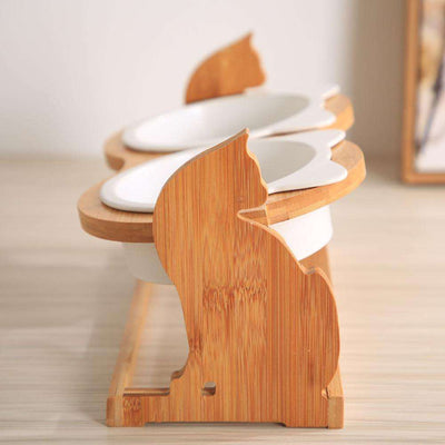 Wooden pet cat food bowl with ceramic dish and decorative stand.