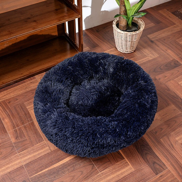 Round, non-slip pet cushion with soft, fluffy plush and anti-skid design.