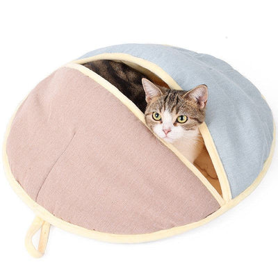 Semi enclosed pet nest in cotton and linen with cat inside, pink and blue design.