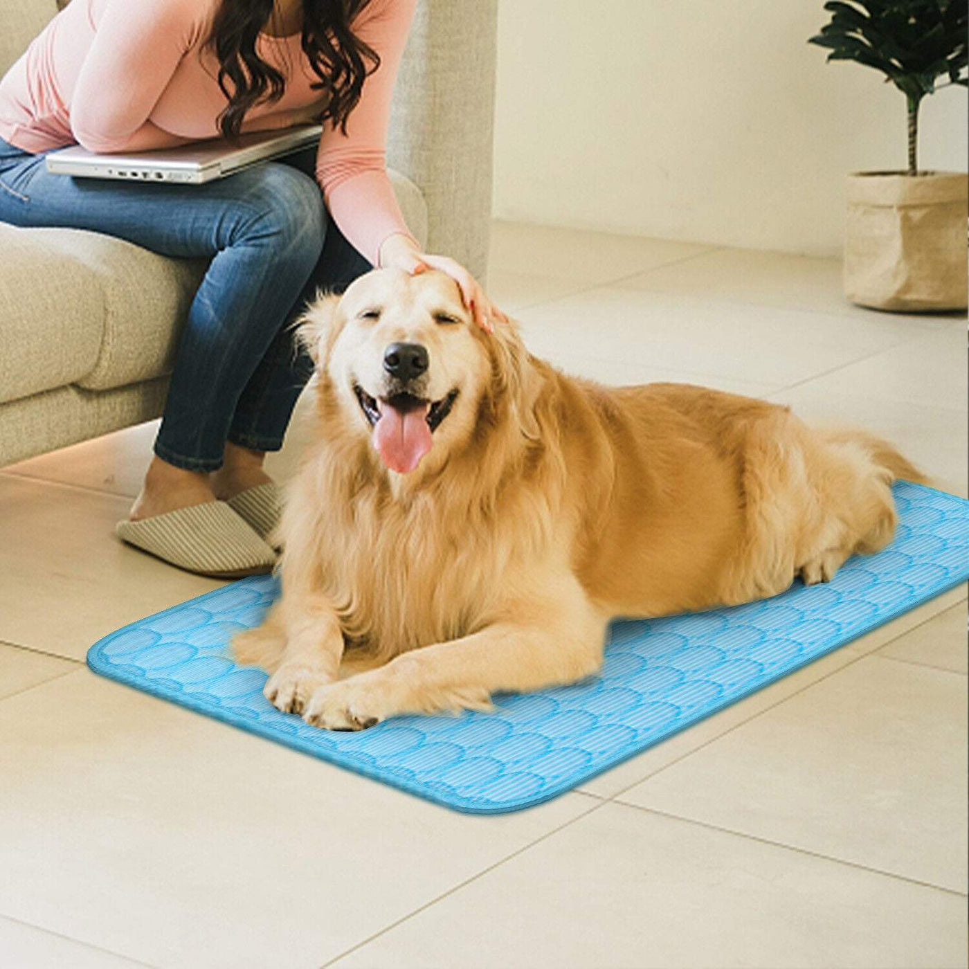 Pet Cooling Mat for dogs, light blue, comfortable lounging on tile floor with owner nearby.